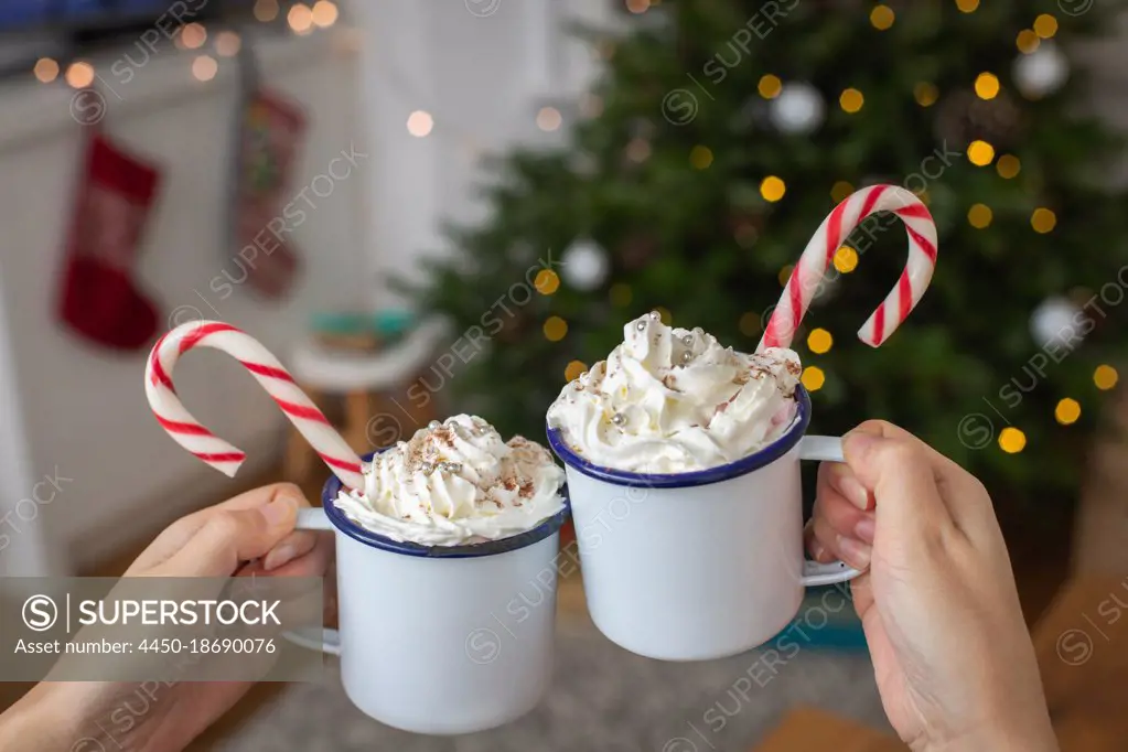 Christmas, mugs of egg nog with whipped cream and candy canes. 