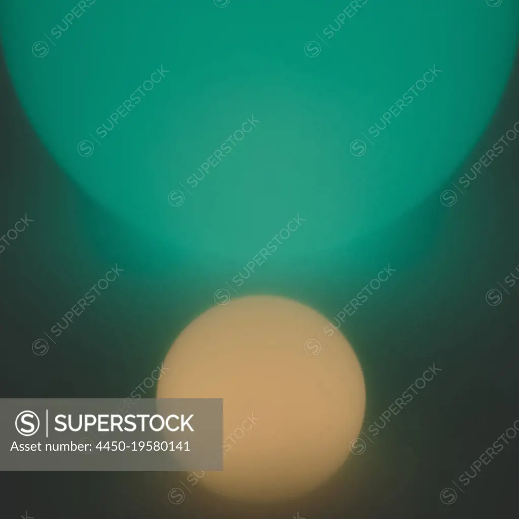 Glowing and illuminated spherical orbs, one large and one small.