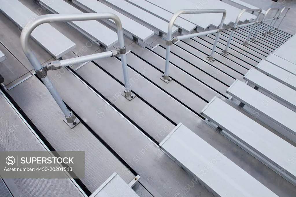 A sports or entertainment stadium. Looking down the steep steps and raked seating. 