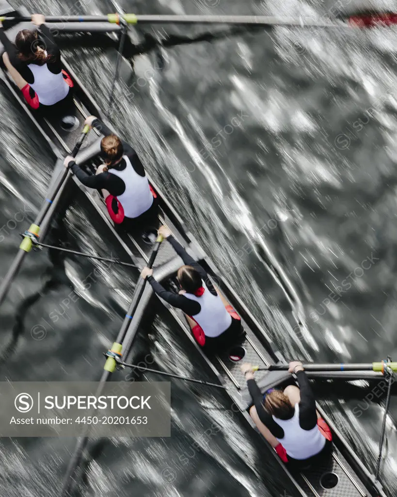 Overhead view of female crew racers rowing in an octuple racing shell, an eights team. 