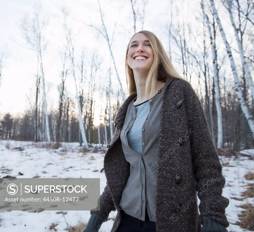 A young woman with long blonde hair outdoors on a winter day. Woodstock, New  York, USA - SuperStock