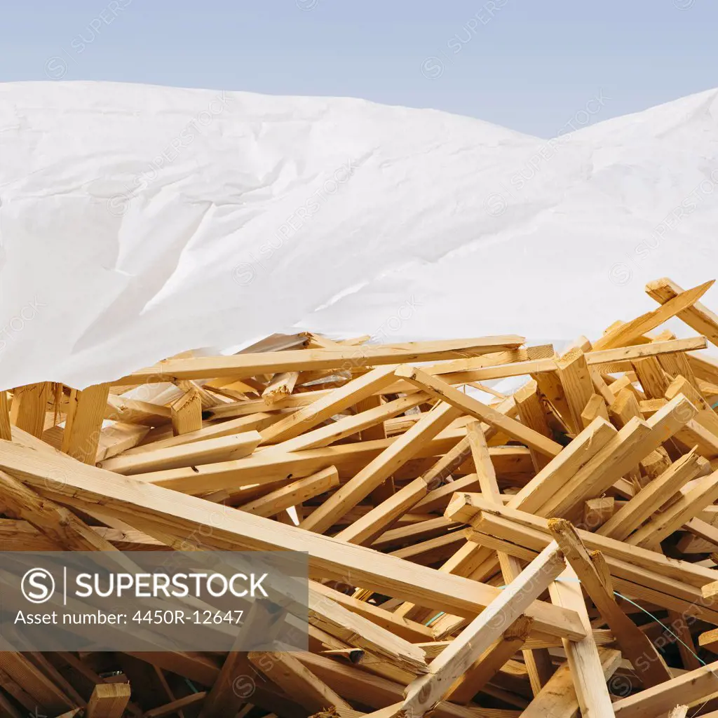 White tarp covering pile of wood 2x4 studs used for construction, near Pullman Pullman, Washington, USA