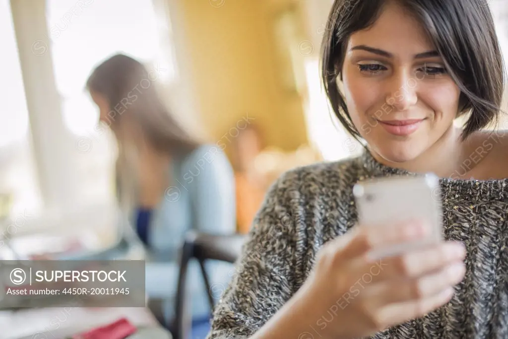 A woman checking her smart phone.