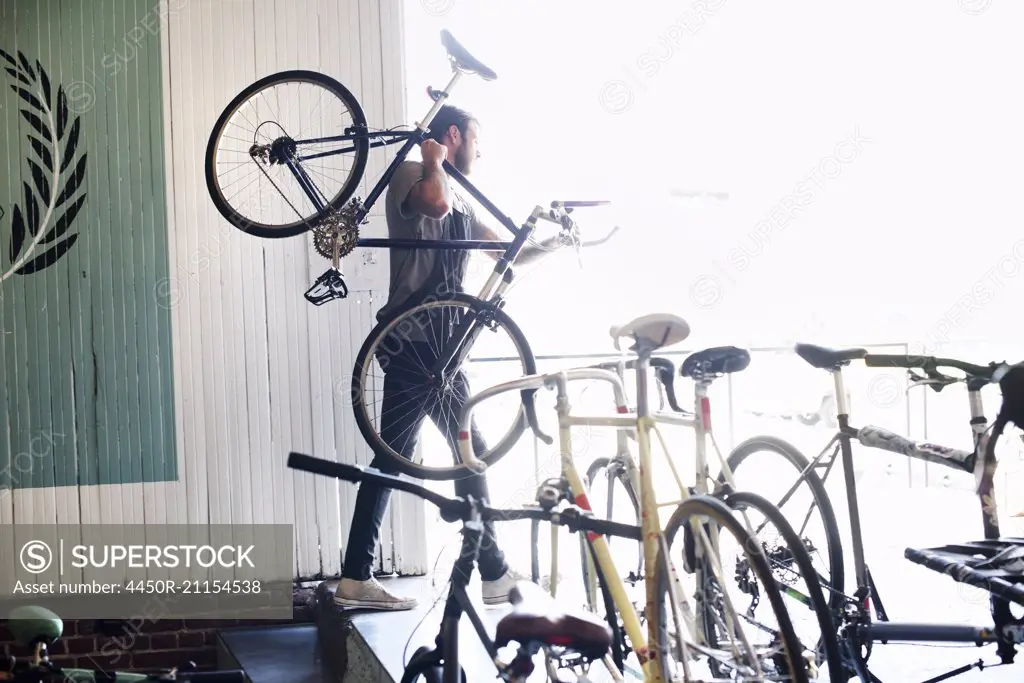 A man working in a bicycle repair shop.