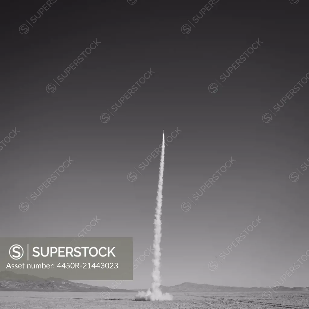 Rocket shooting into vast, desert sky, Black Rock Desert, Nevada