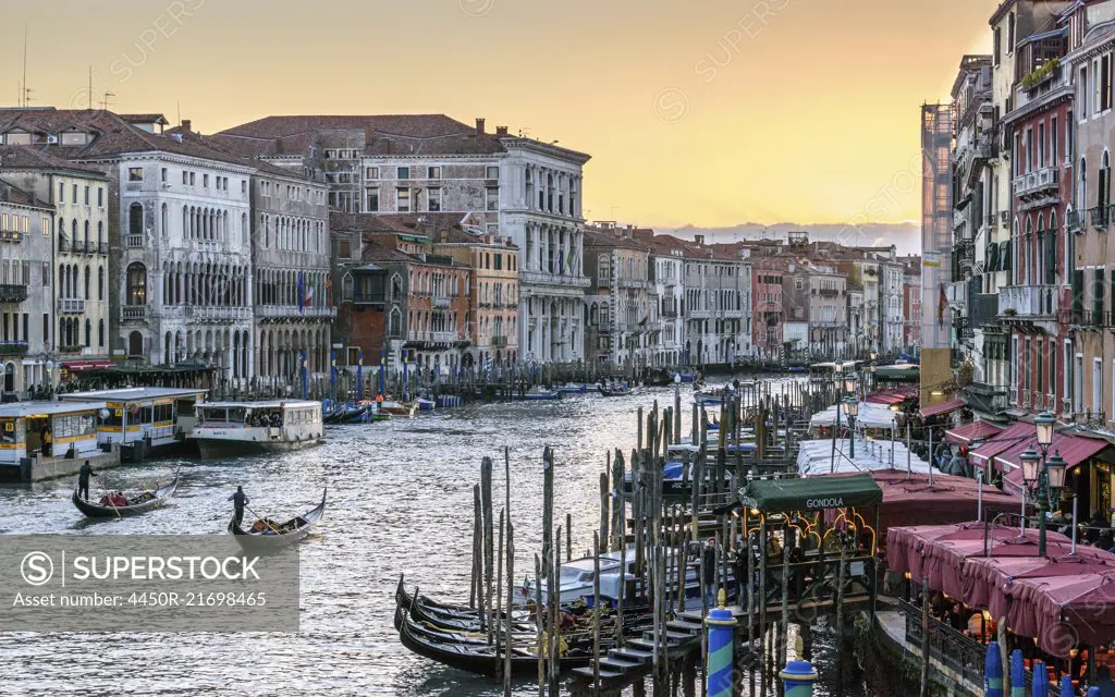 Gondolas moored on a canal lined with historic houses, Venice, Italy.