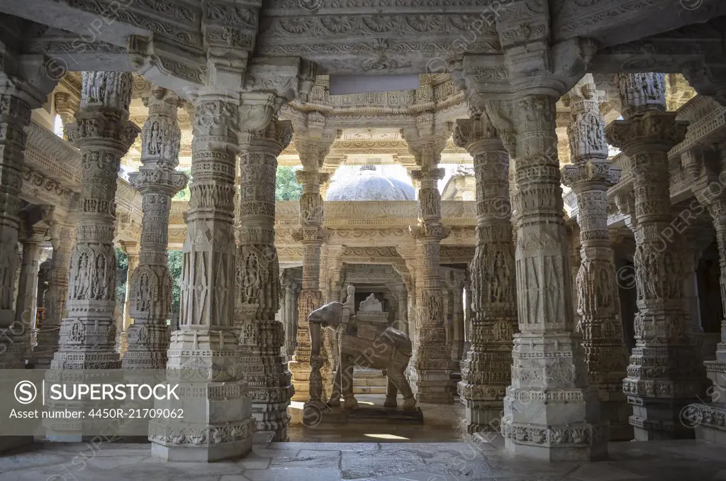 Interior view of Ranakpur Jain Temple, Ranakpur. Carvings and marble columns and a statue of an elephant.