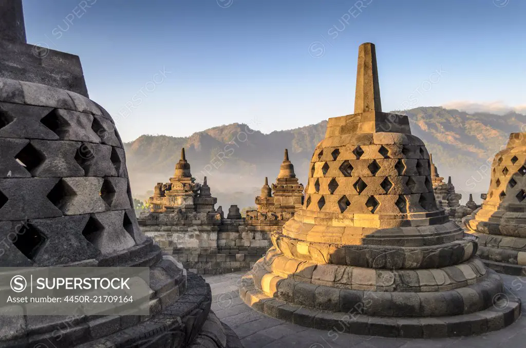 Borobudur temple, a 9th century Buddhist temple with terraces and stupa with latticed exterior, bell temples housing Buddha statues.  UNESCO world heritage site.