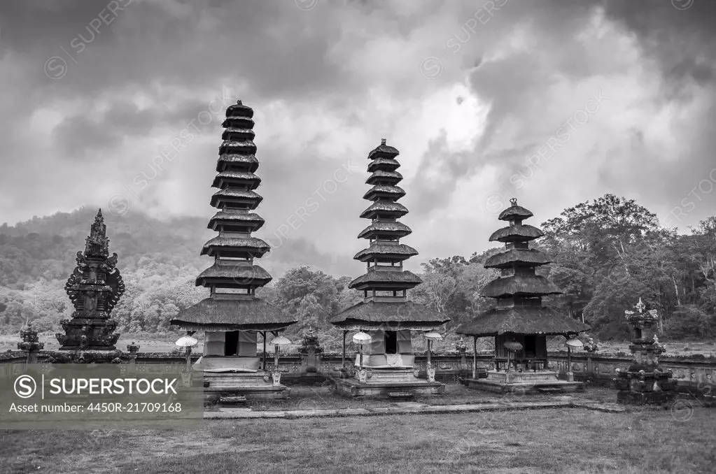 Balinese Hindu Temple, traditional architecture and tall towers with tiered tapering roofs in a valley by Lake Bratan.