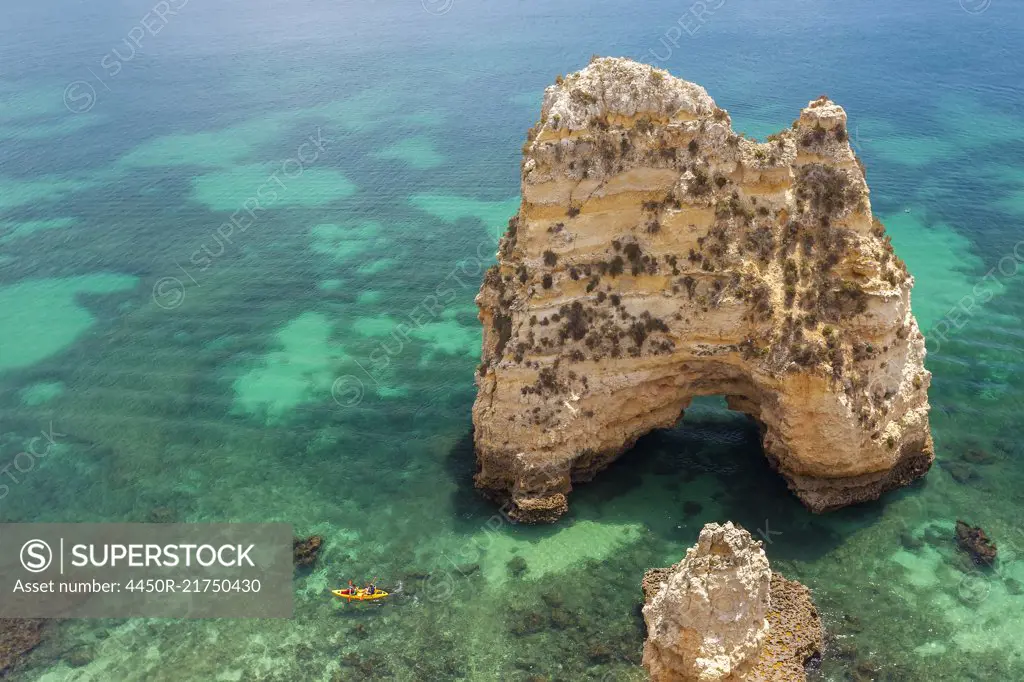 High angle view of rock formation in clear ocean.