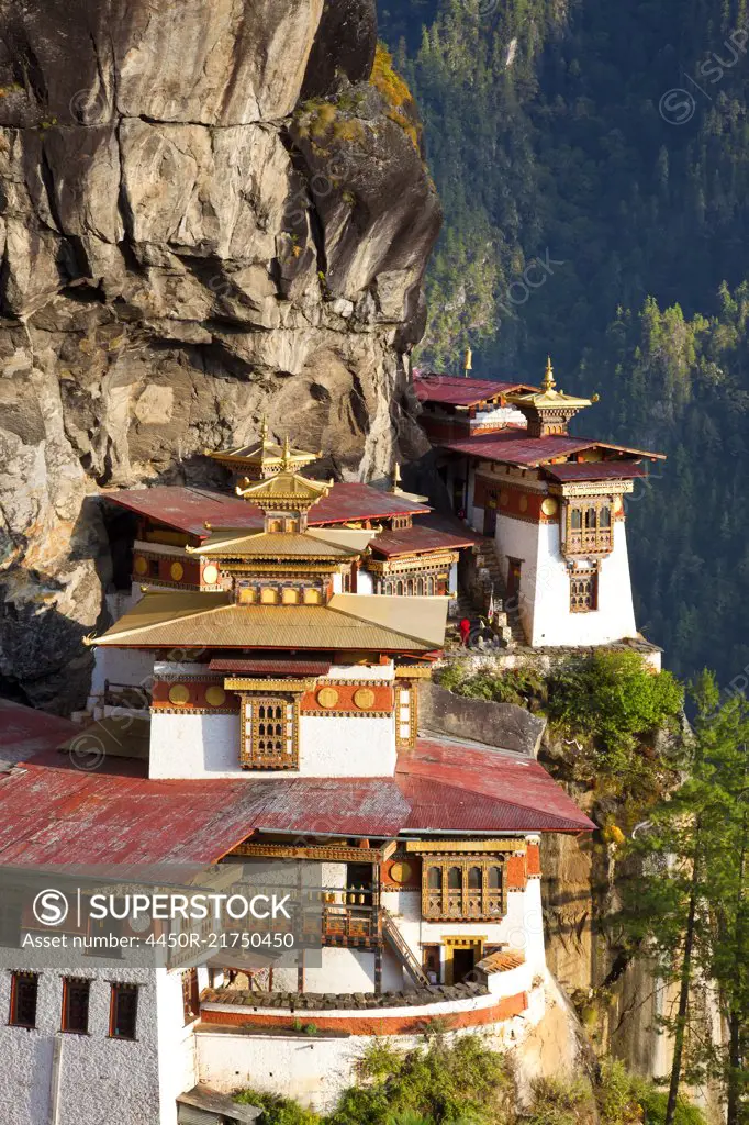 High angle view of Himalayan Buddhist sacred site and temple complex perched on a vertical rockface.