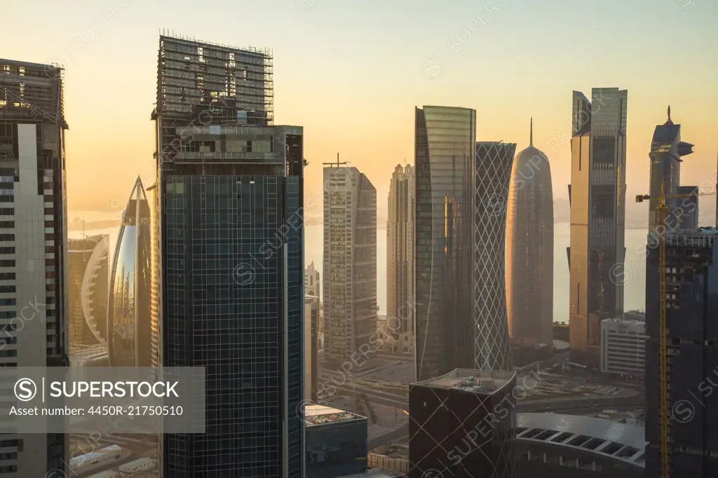 Cityscape with tall modern skyscrapers at dusk.