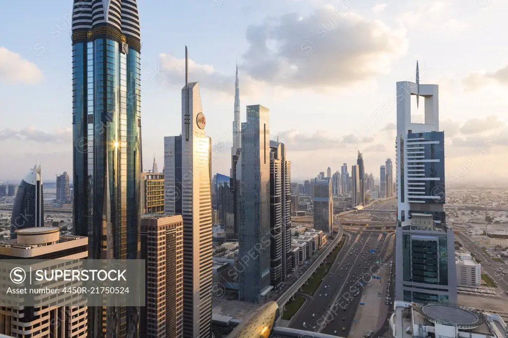 Cityscape with tall modern skyscrapers under a cloudy sky.