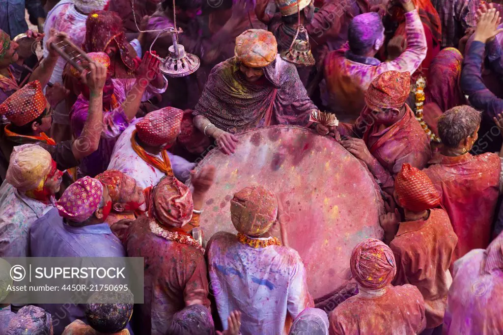 High angle view of crowds of people covered in colour at Holi, a Hindu spring festival.