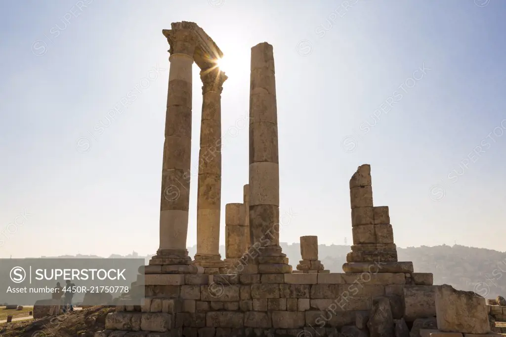 Ancient ruin of temple with architrave fragments and columns.