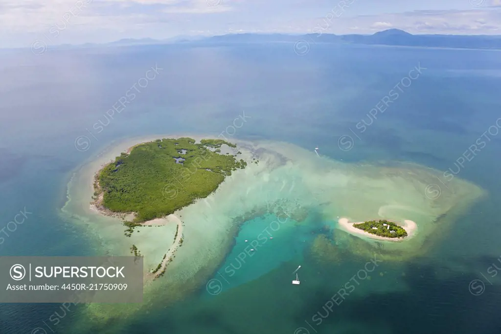 Aerial view of island with lighthouse in the Pacific Ocean.