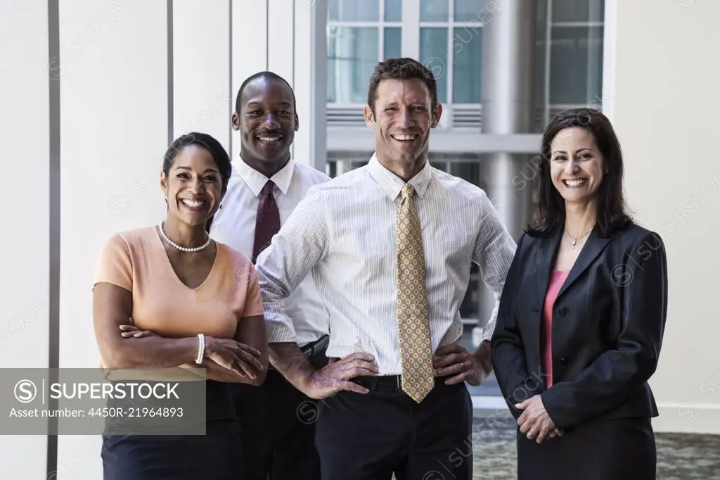 Mixed race business people together as a team in a business centre.