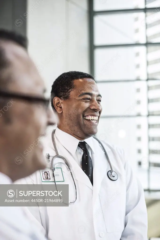 Black man doctor in lab coat with a stethoscope.