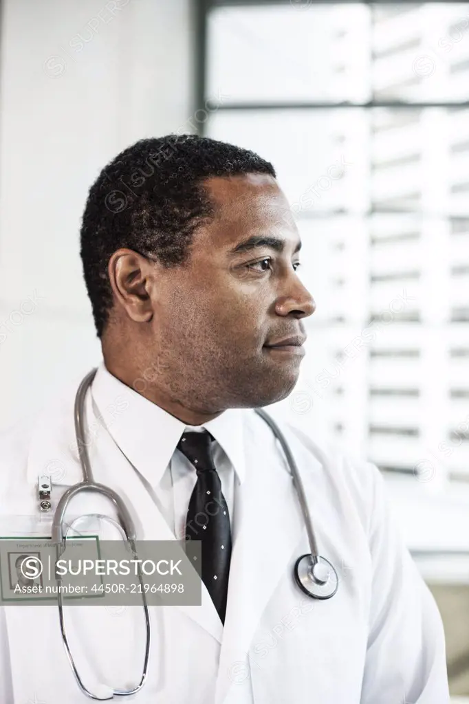 Black man doctor in lab coat with a stethoscope.