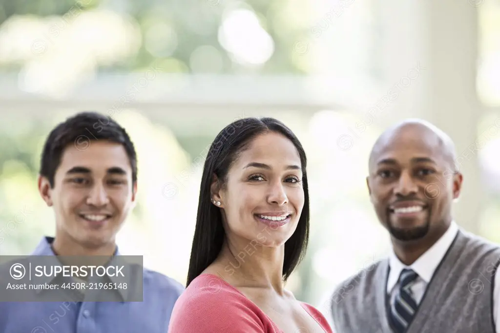 Mixed race team of business people at a table in a business centre.