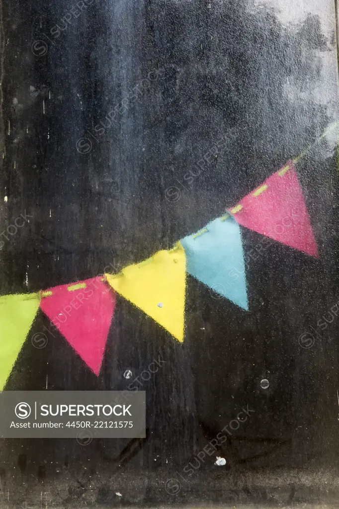 Close up of colorful bunting in an allotment.