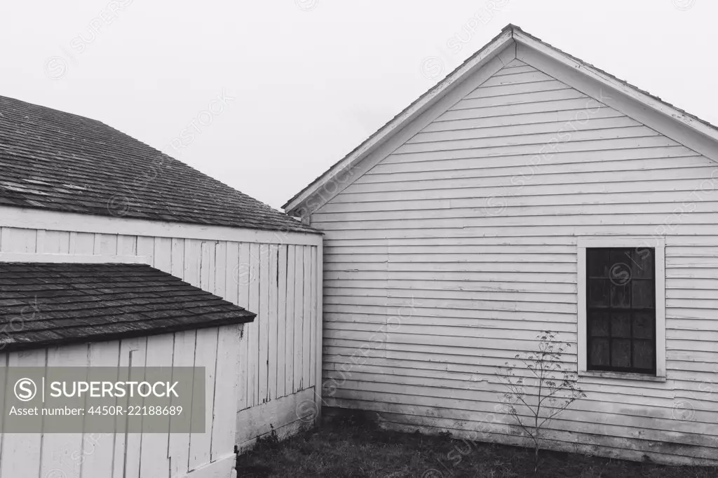 Outbuildings and barn on farm in dense fog in California, USA.