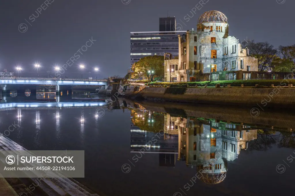 Genbaku Dome reflected in lake at night, Hiroshima, Japan.