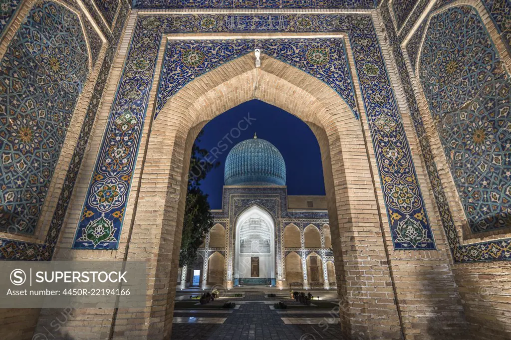 Archway inlaid with vibrant mosaic tile patterns, The Registan, a historic 15th century Madrasa building.