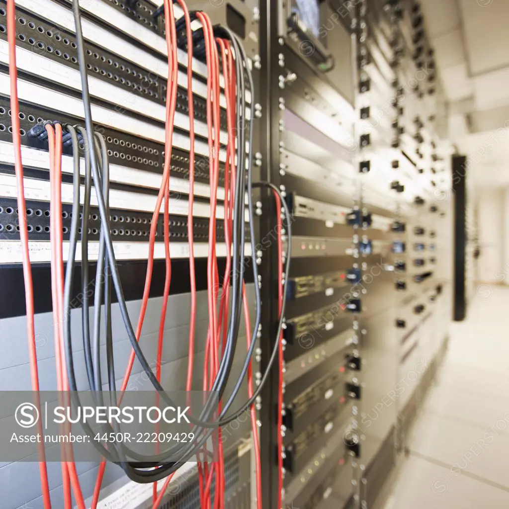 Close up of computer servers and cords in server room