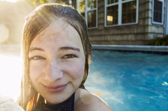 Portrait of a teenage girl in a swimming pool, head and shoulders