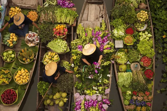 Aerial view of a floating market on a canal in Bangkok, local boats laden with fresh food, moored close together.  April 3, 2005