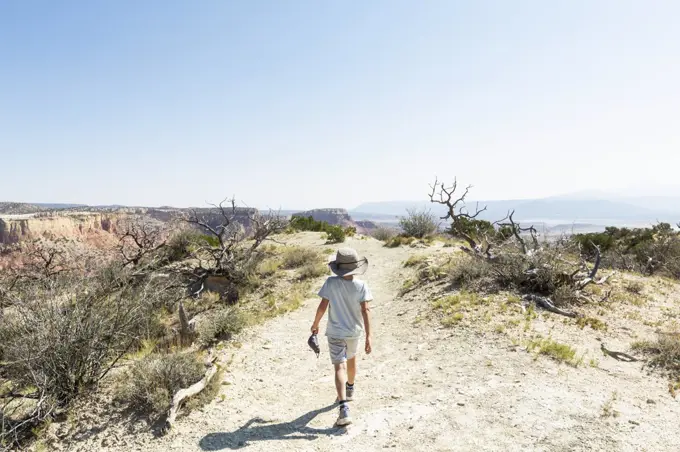 young boy hiking on Chimney Rock trail, through a protected canyon landscape