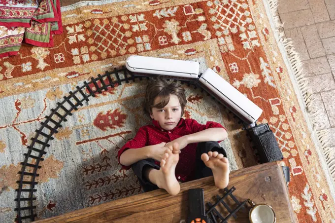 overhead view of young boy playing with his train