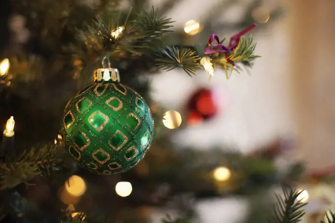 Close up of shiny green and red Christmas tree decorations, 