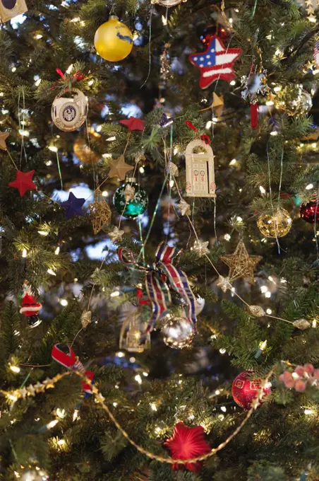 Close up of a Christmas tree, pine tree branch crowded with ornaments