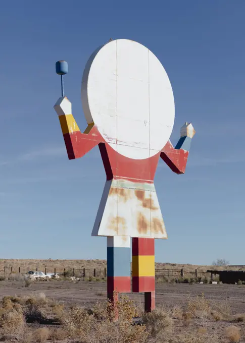 Old roadside attraction sign, a figure of a person with late for a head, cafe sign. 