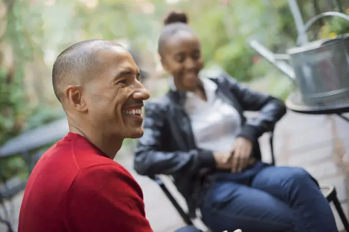 Scenes from urban life in New York City. A man and a teenage girl sitting outdoors. Laughing. New York city, USA