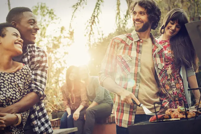 A group of friends at a summer evening barbeque.