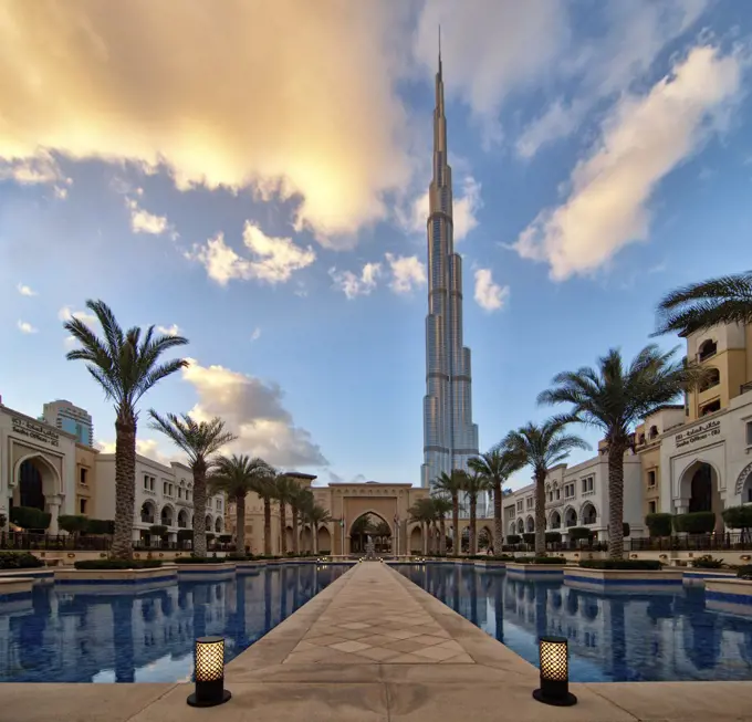 Hotel swimming pool with Burj Khalifa skyscraper in the distance, Dubai, United Arab Emirates.