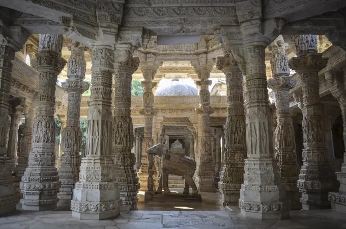 Interior view of Ranakpur Jain Temple, Ranakpur. Carvings and marble columns and a statue of an elephant.