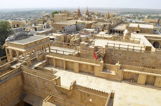 The historic hillfort sandstone buildings of Jaisalmer, elevated view of courtyards and rooftops.