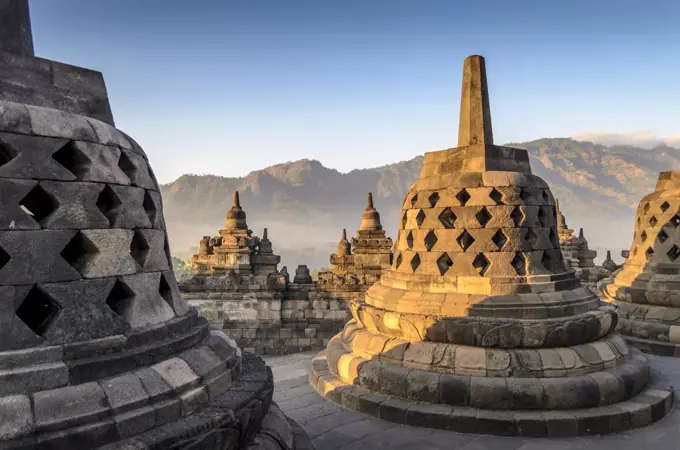 Borobudur temple, a 9th century Buddhist temple with terraces and stupa with latticed exterior, bell temples housing Buddha statues.  UNESCO world heritage site.