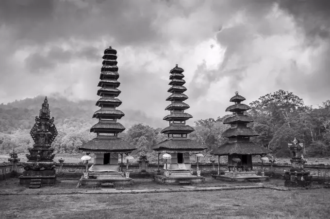 Balinese Hindu Temple, traditional architecture and tall towers with tiered tapering roofs in a valley by Lake Bratan.