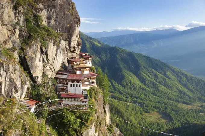 High angle view of  Himalayan Buddhist sacred site and temple complex perched on a vertical rockface.