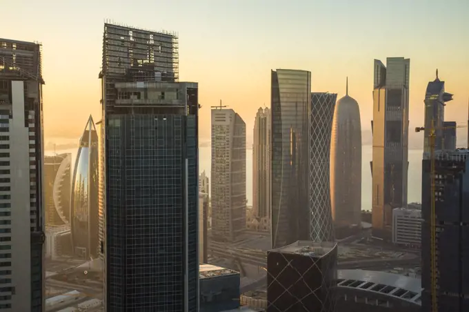 Cityscape with tall modern skyscrapers at dusk.