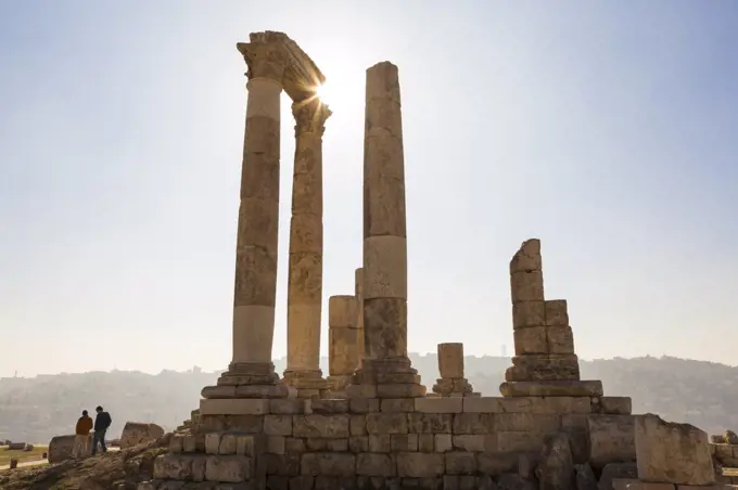 Ancient ruin of temple with architrave fragments and columns.