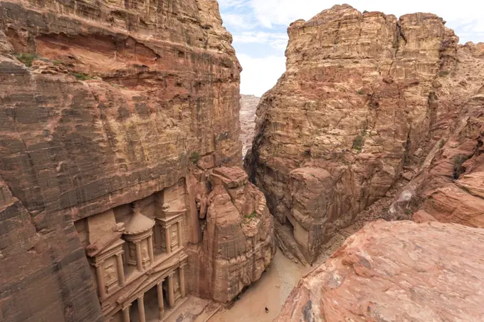 High angle exterior view of the rock-cut architecture of Al Khazneh or The Treasury at Petra, Jordan.