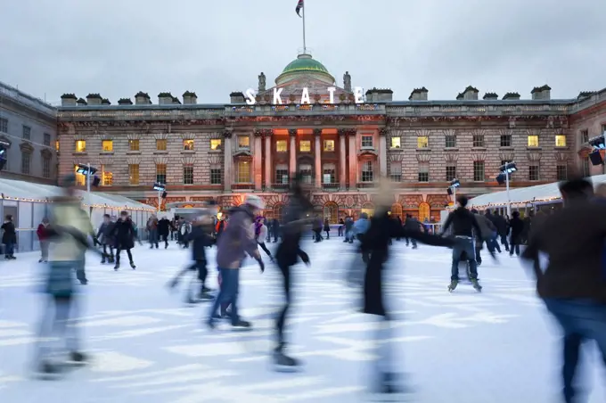 Ice skaters on the ice rink in the courtyard of Somerset House, London, UK.