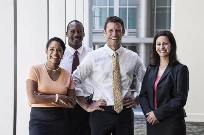 Mixed race business people together as a team in a business centre.