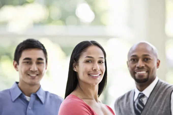 Mixed race team of business people at a table in a business centre.